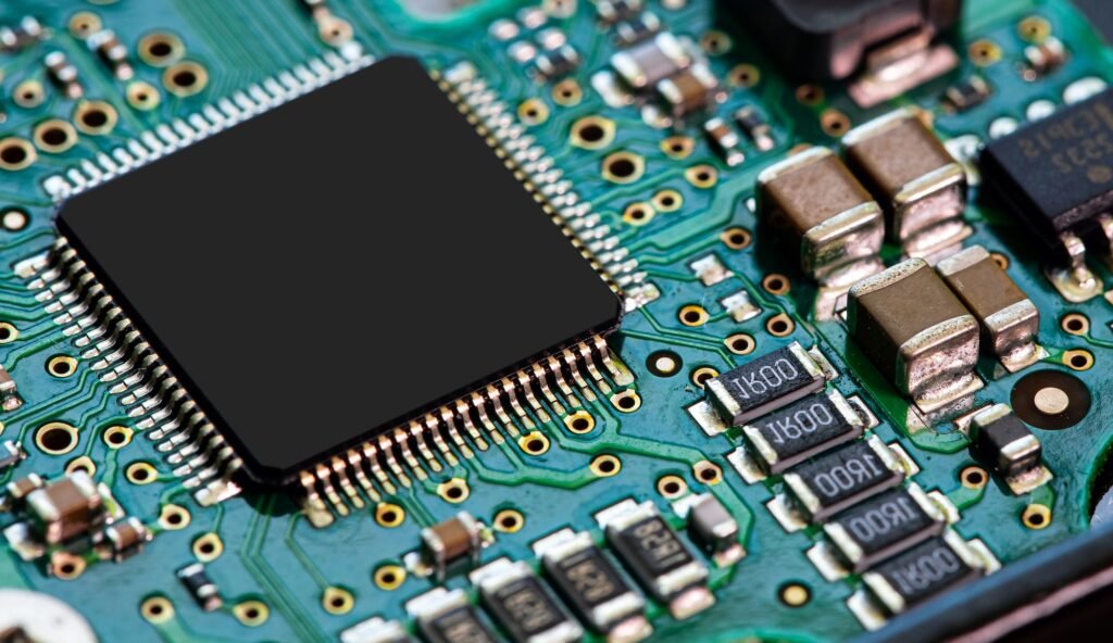 Closeup of an electronic circuit board, featuring a variety of electronic chips and microcircuits