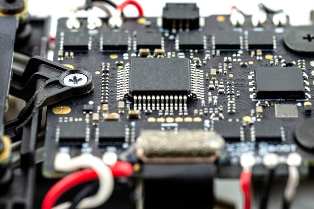 Macro pictures of an integrated circuit on a black PCB with a processor and semiconductors