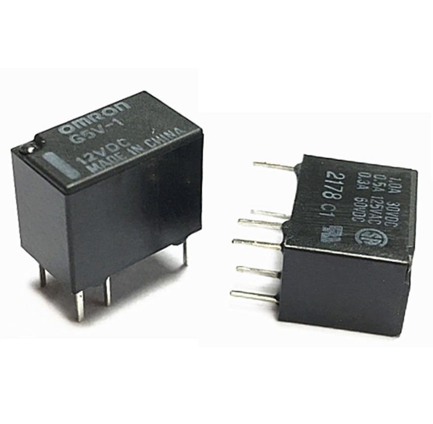 A pair of relay switches displayed against a white background, highlighting their structure and electrical components effectively.