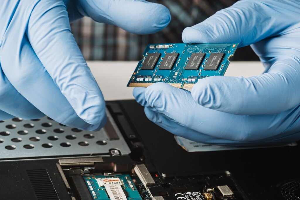 Gloved hands holding a computer ram memory module