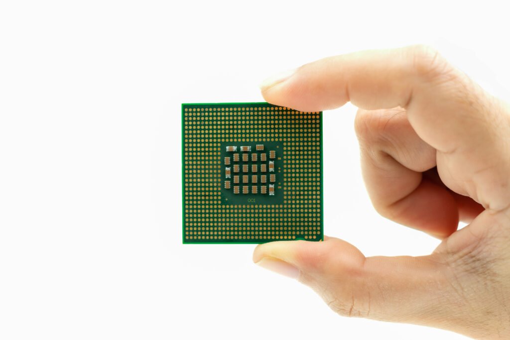 Realistic cpu back view processor chip in hand