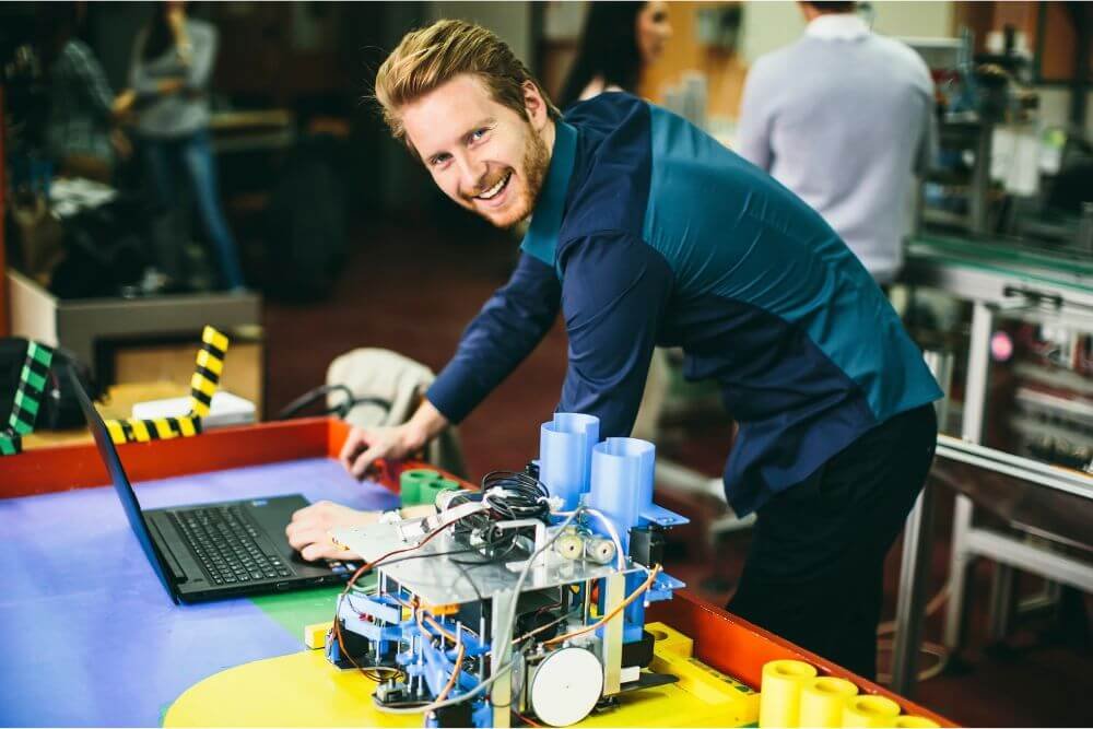 A worker in the middle of a factory manufacturing capacitors